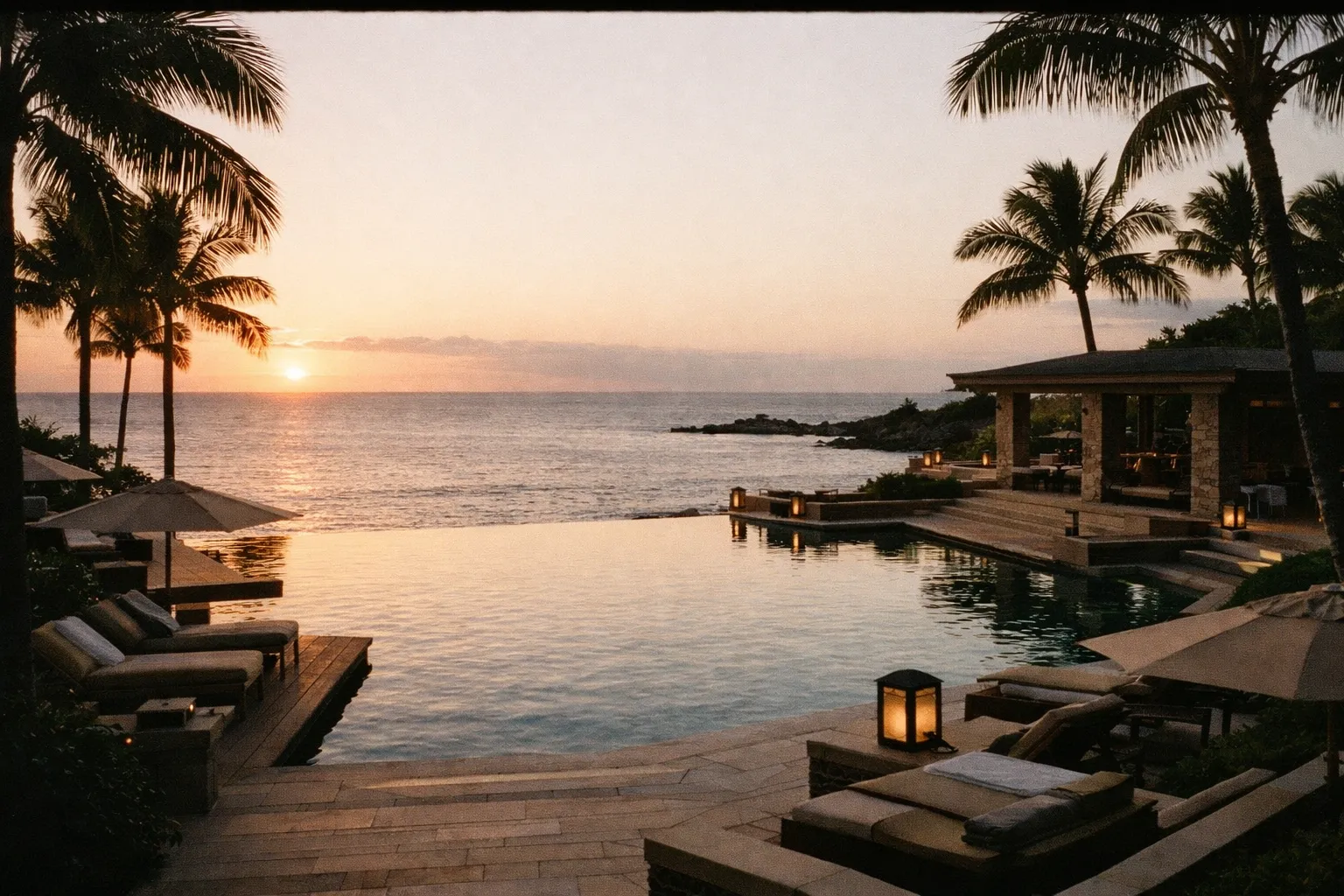 Infinity pool at a luxury Hawaii resort at sunset.