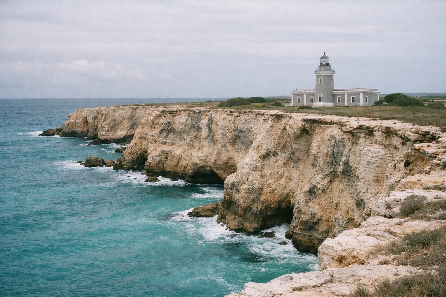 Los Morrillos Lighthouse sits atop rugged cliffs overlooking the blue ocean in Cabo Rojo, Puerto Rico.