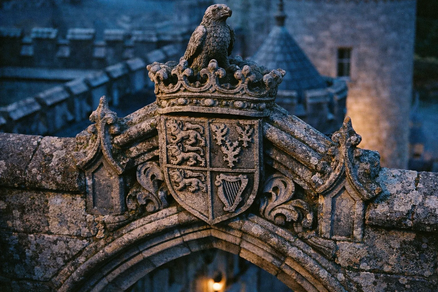 Stone crest with a harp and lion carvings atop an arched entrance at an Irish castle hotel.