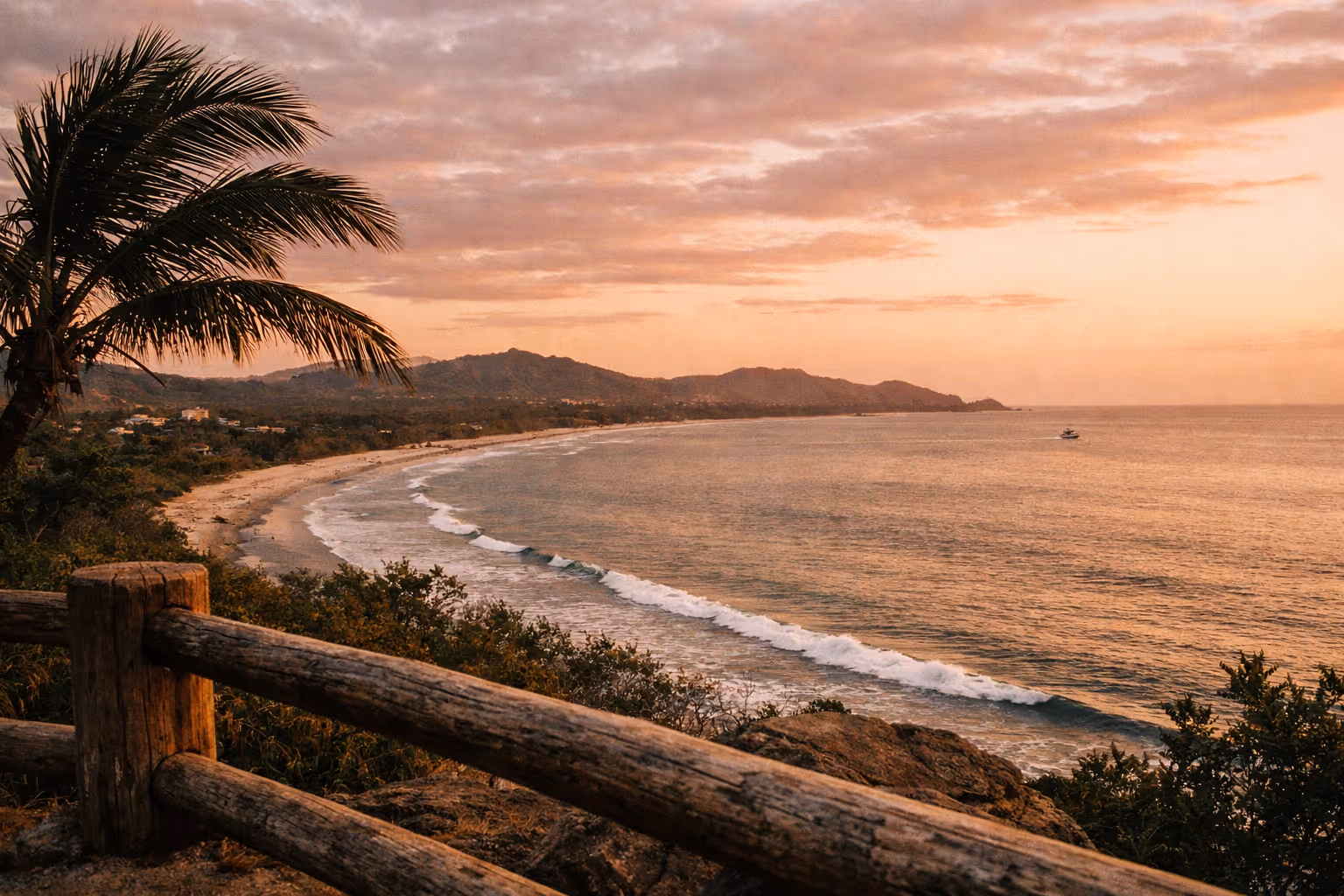 Tamarindo coastline at golden hour with palm silhouettes and distant surfers