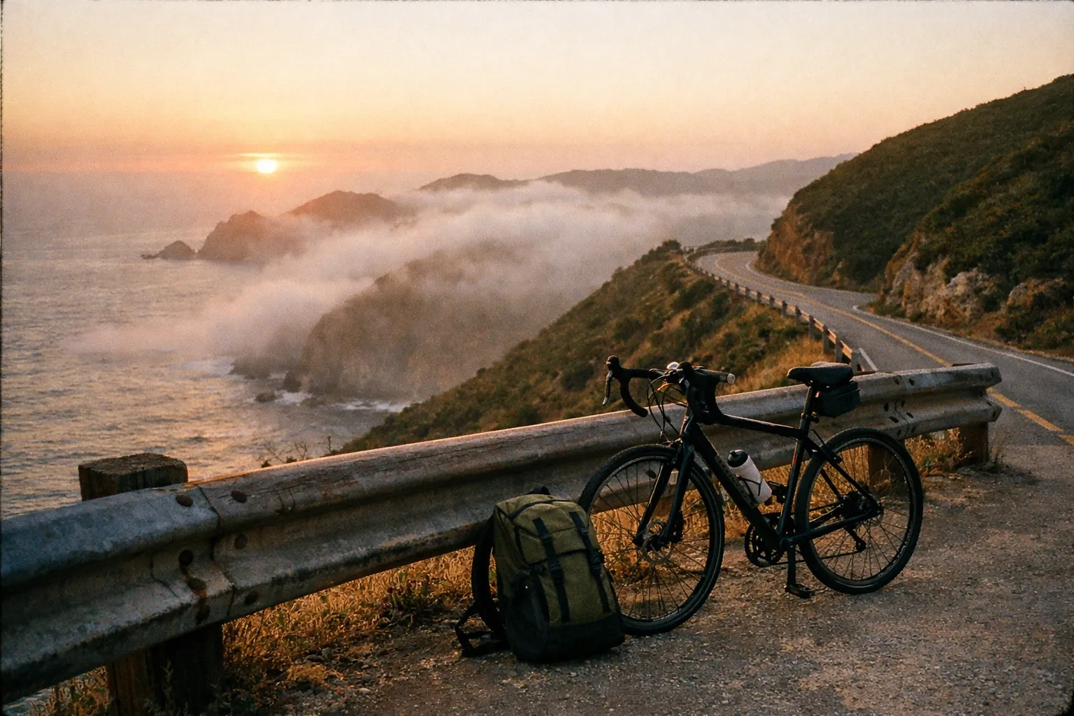 Sunset coastal overlook with a bicycle and backpack resting by a railing