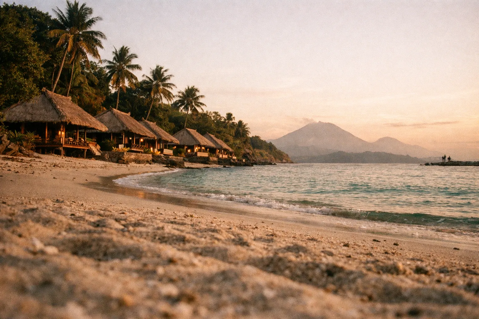 Sunset view of traditional beach bungalows along Bali's coastline