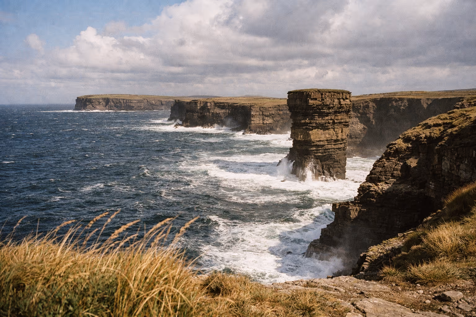 Dramatic sea cliffs and the sea stack of Downpatrick Head on the Mayo coastline in Ireland.
