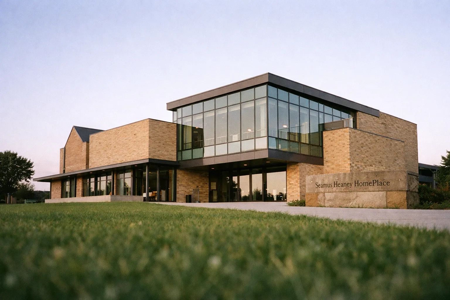 Seamus Heaney HomePlace, a modern brick and glass building, stands on a grassy lawn in northern Ireland.
