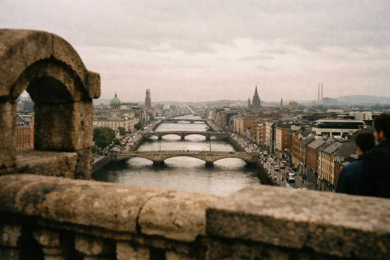 View over the River Liffey and bridges running through central Dublin, Ireland, seen from an elevated terrace.