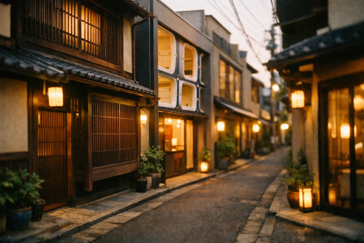 Kyoto-style alley with a row of diverse lodgings—machiya, capsule hotel, and modern inn—bathed in warm light.