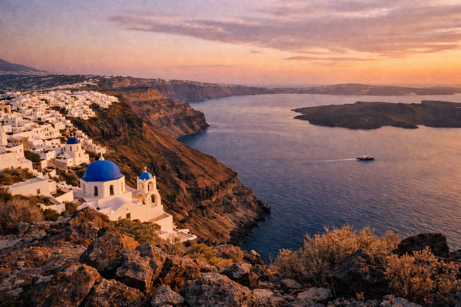 Caldera view at golden hour showing Santorini's volcanic origins with cliffside village terraces and distant ferry
