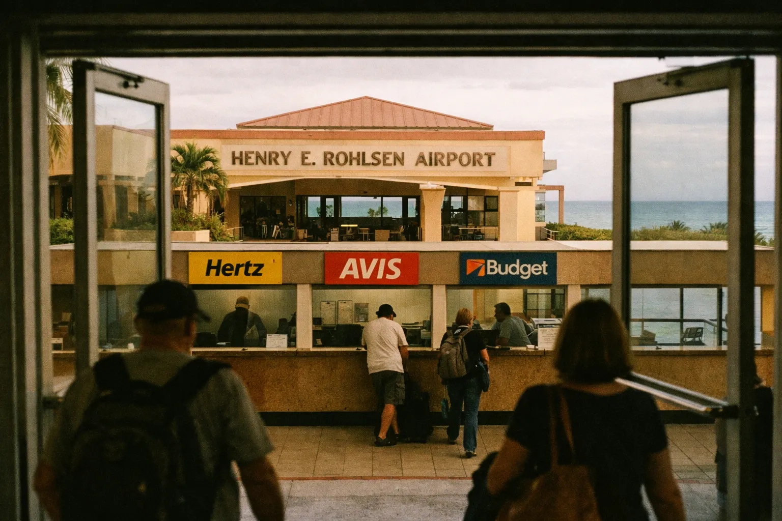 Travelers walk toward car rental counters at Henry E. Rohlsen Airport in St. Croix, US Virgin Islands.