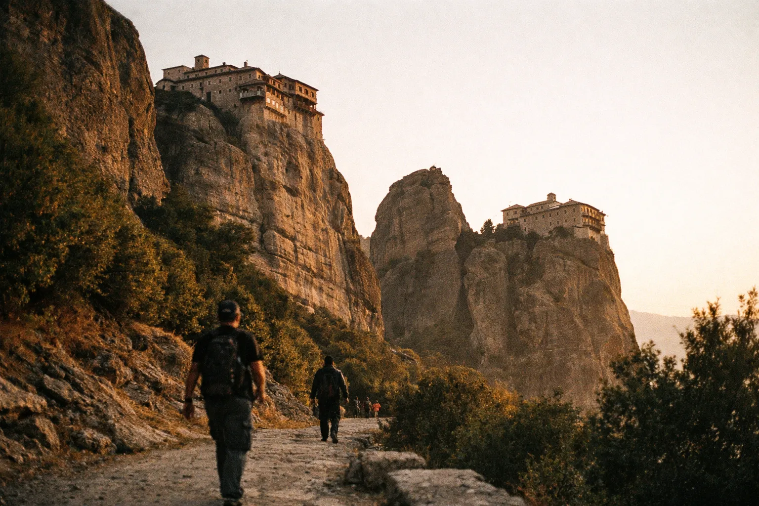 Hikers walk toward the Meteora monasteries perched on top of towering rock formations in mainland Greece.