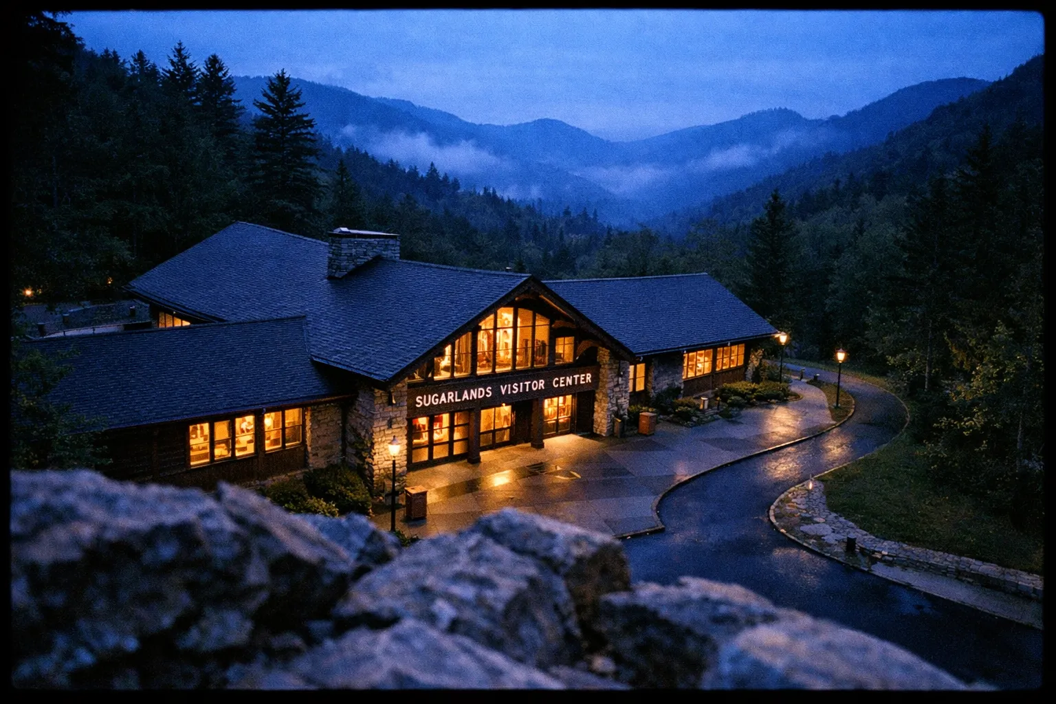 Sugarlands Visitor Center sits nestled among forested hills at dusk in the Great Smoky Mountains.