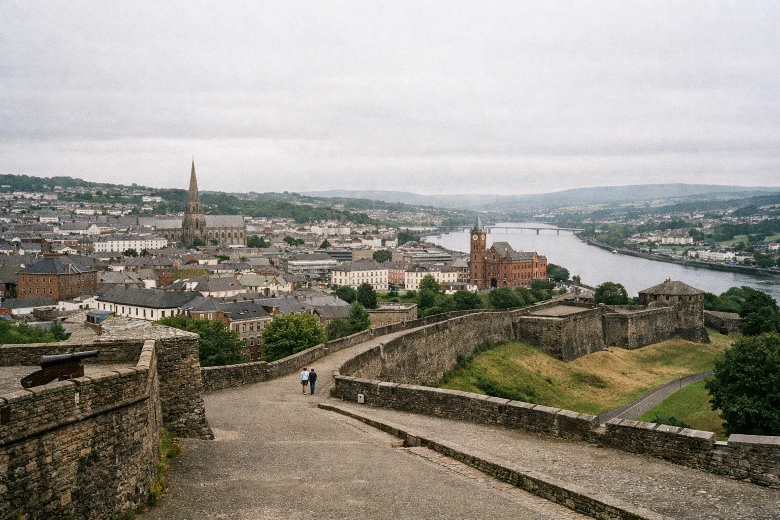 A view of Derry's old city walls overlooking the city, the Guildhall, and the River Foyle in Northern Ireland.