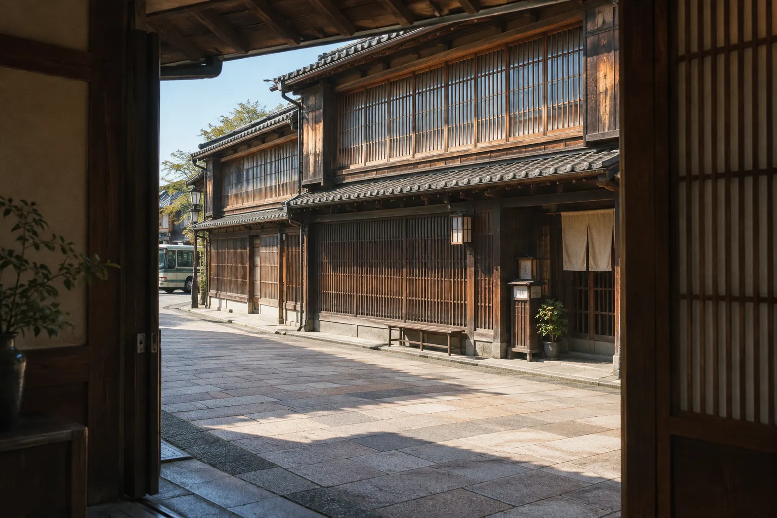 Traditional wooden townhouses line a stone-paved street in Kanazawa's Higashi Chaya District.