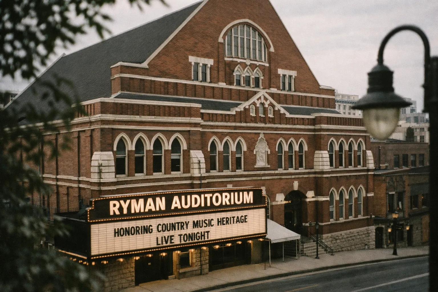 Ryman Auditorium in Nashville with its marquee lit up on a quiet street.