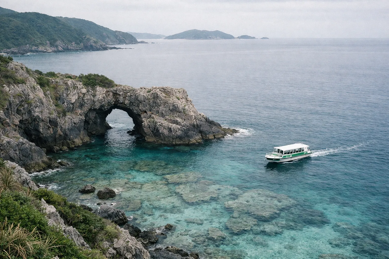 A sightseeing boat passes by the natural rock arch at Okinawa's scenic coastline.