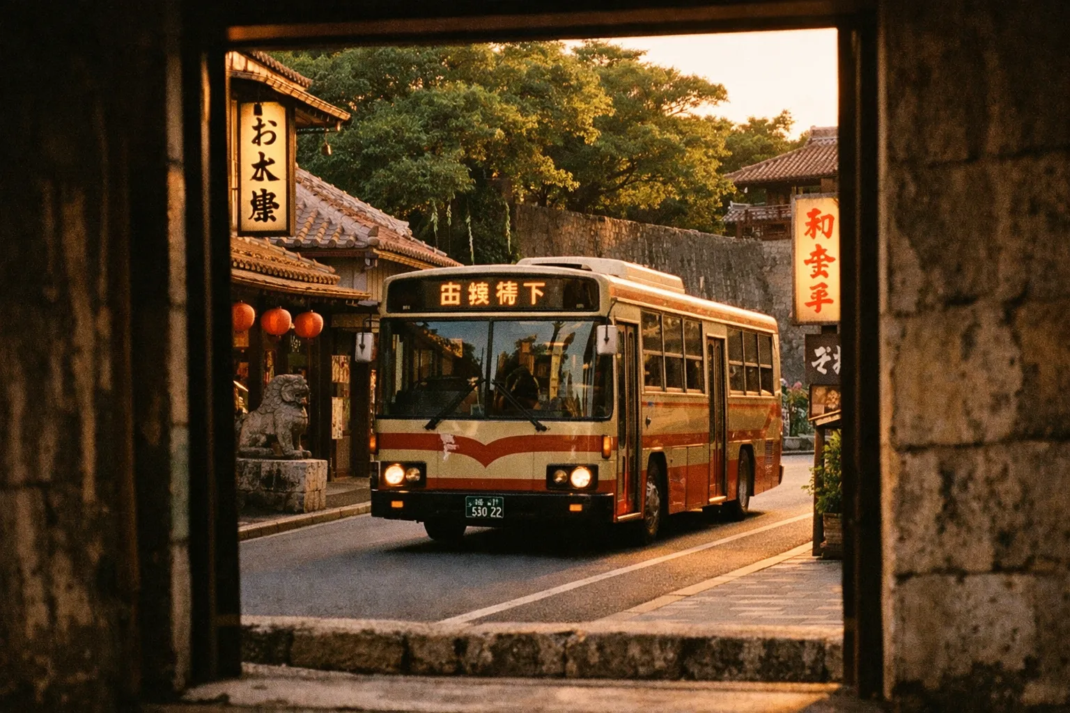 A local bus drives through a traditional street near stone walls and tiled roofs in Okinawa.