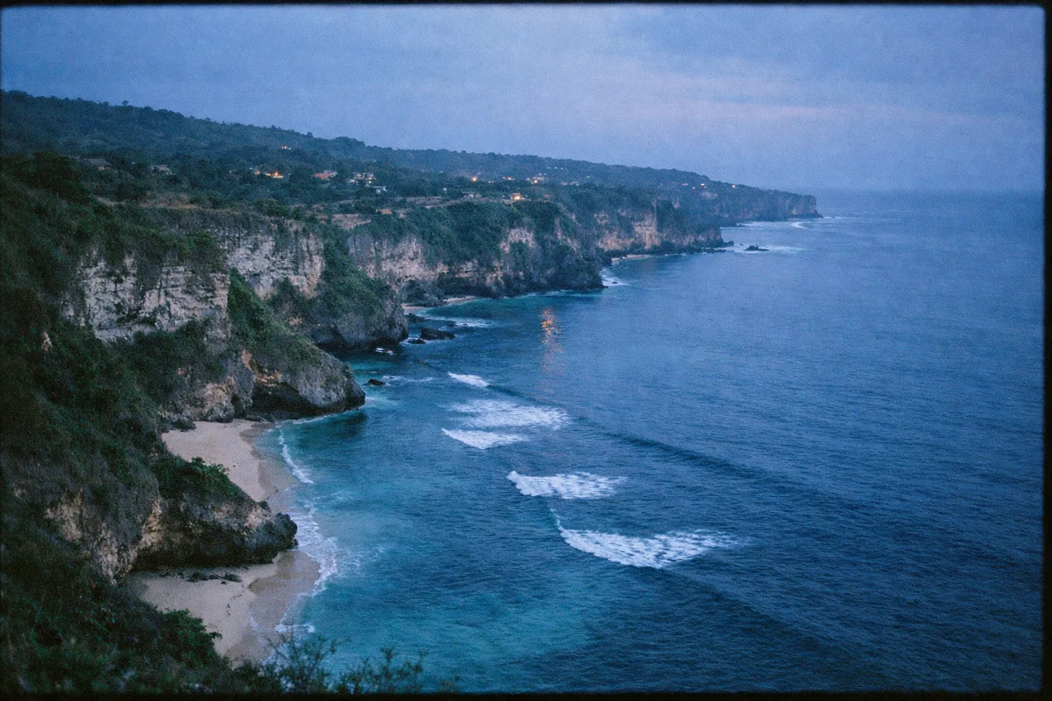 Steep cliffs and sandy beaches along the coastline at Uluwatu in Bali.
