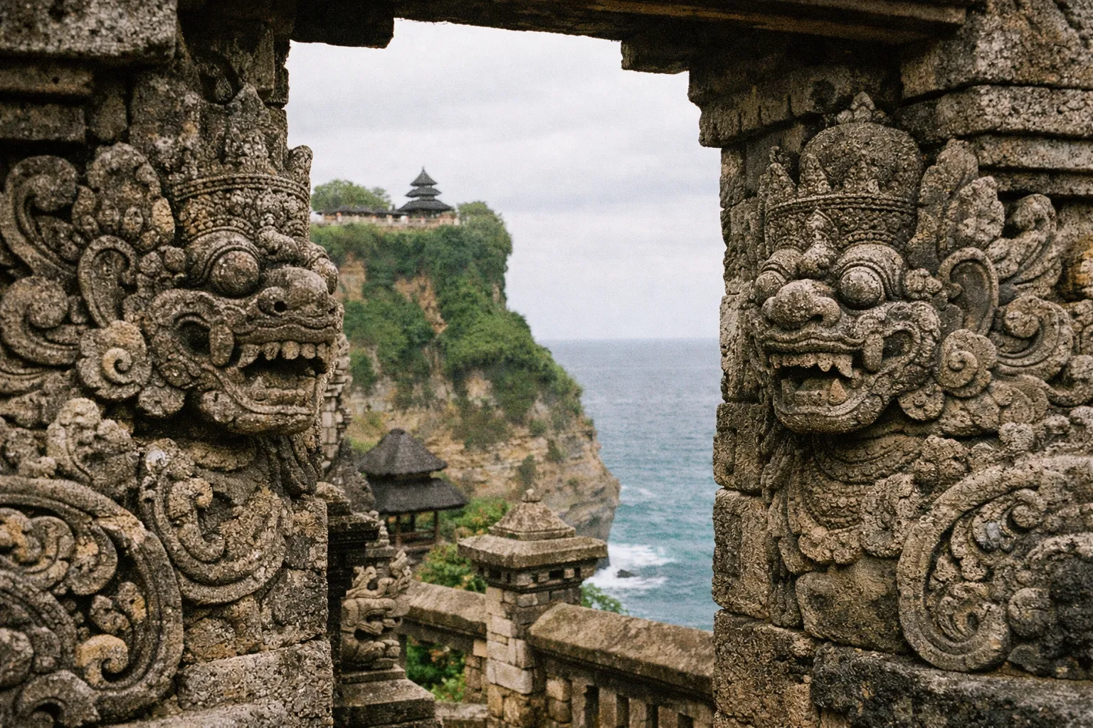 Stone carvings at Uluwatu Temple overlook dramatic cliffs above the ocean in Bali.