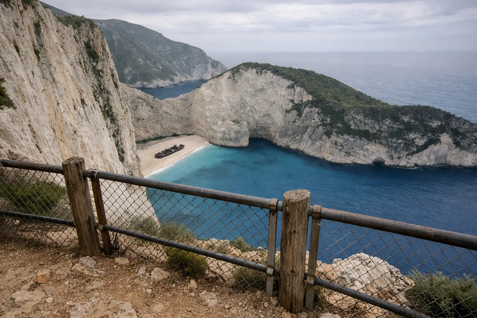 Navagio Beach with its shipwreck and dramatic cliffs viewed from an overlook on Zakynthos, Greece.
